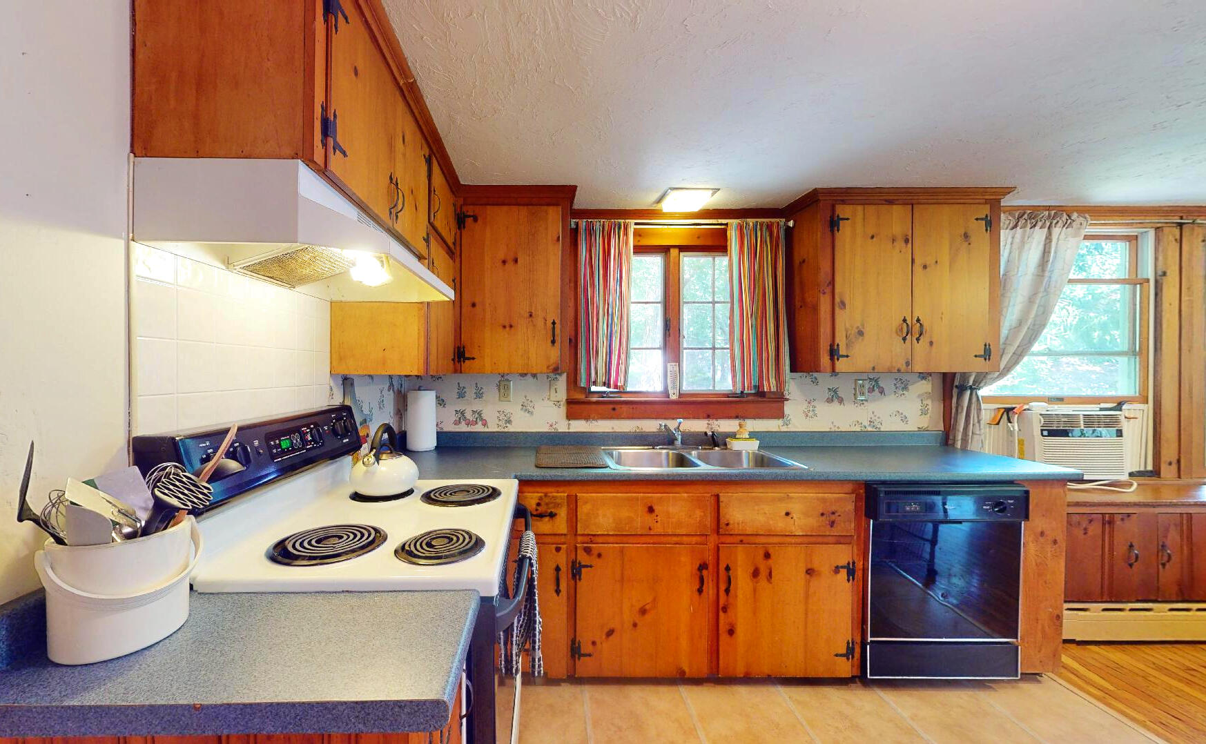 6 South Highland Road Truro, MA 02666 - Photo 9 of 27 a kitchen with a stove a sink and a microwave