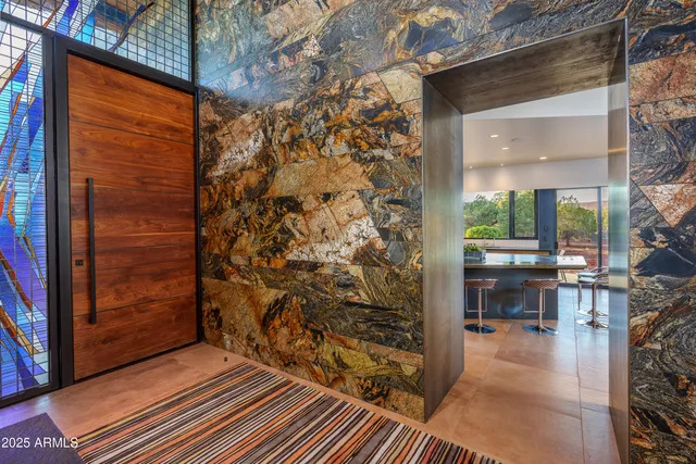 a room with table chairs and window