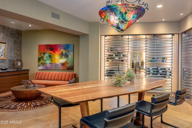 a room with lots of table tennis table and a chandelier