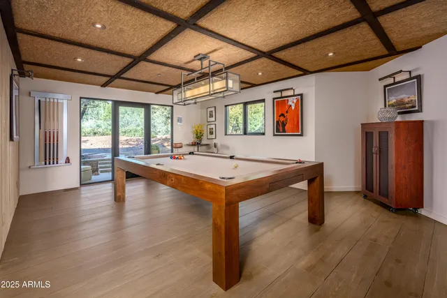 an aerial view of residential houses with outdoor space and trees