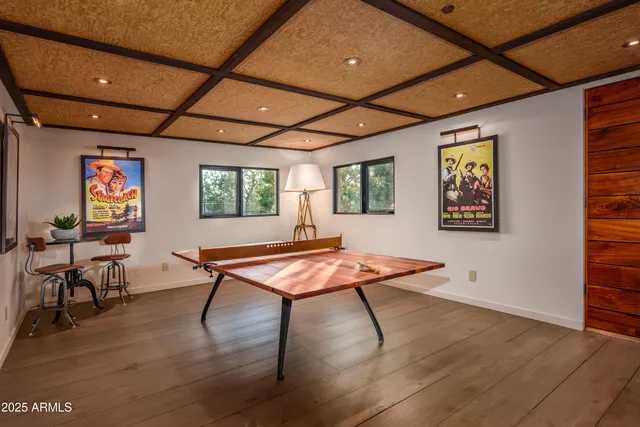 an aerial view of a house with a yard and mountain view