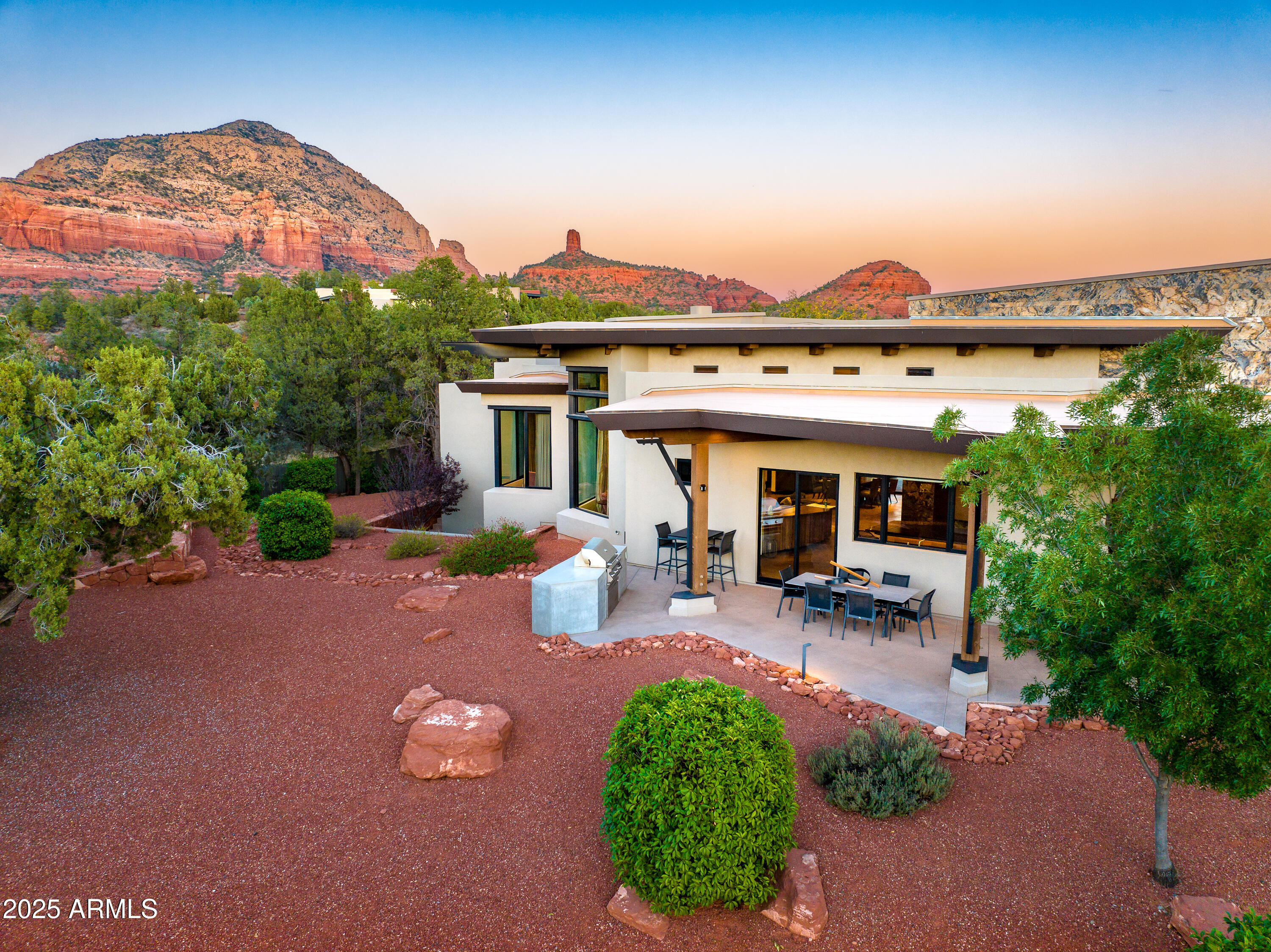 120 Paisano Road Sedona, AZ 86336 - Photo 56 of 63 a view of a patio with table and chairs under an umbrella