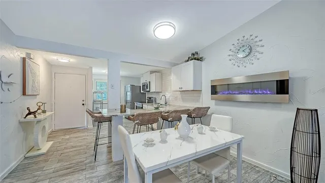 a kitchen with stainless steel appliances granite countertop a stove top oven a sink dishwasher and a microwave oven with wooden cabinets