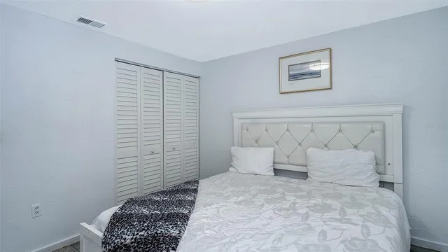a view of a balcony with chairs and wooden fence