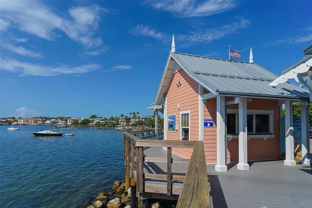 a front view of multi story residential apartment building with yard and sign board