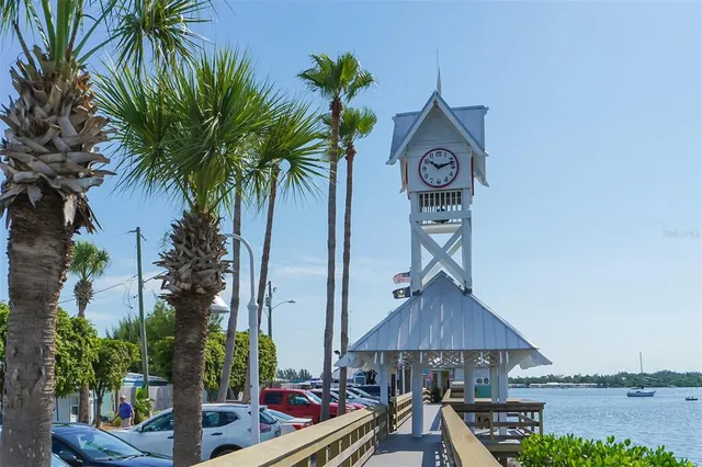 a view of a lake with a yard and table and chairs
