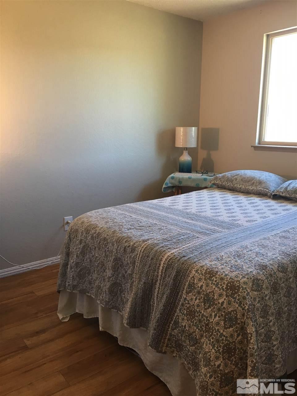 10003 Albite Street Reno, NV 89506 - Photo 18 of 25 a bed sitting in a bedroom next to a window