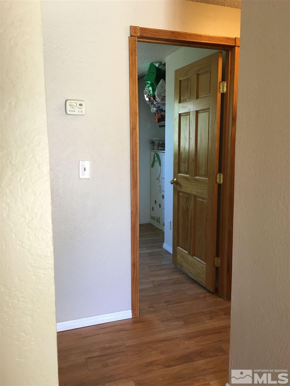 10003 Albite Street Reno, NV 89506 - Photo 20 of 25 a view of a hallway with wooden floor