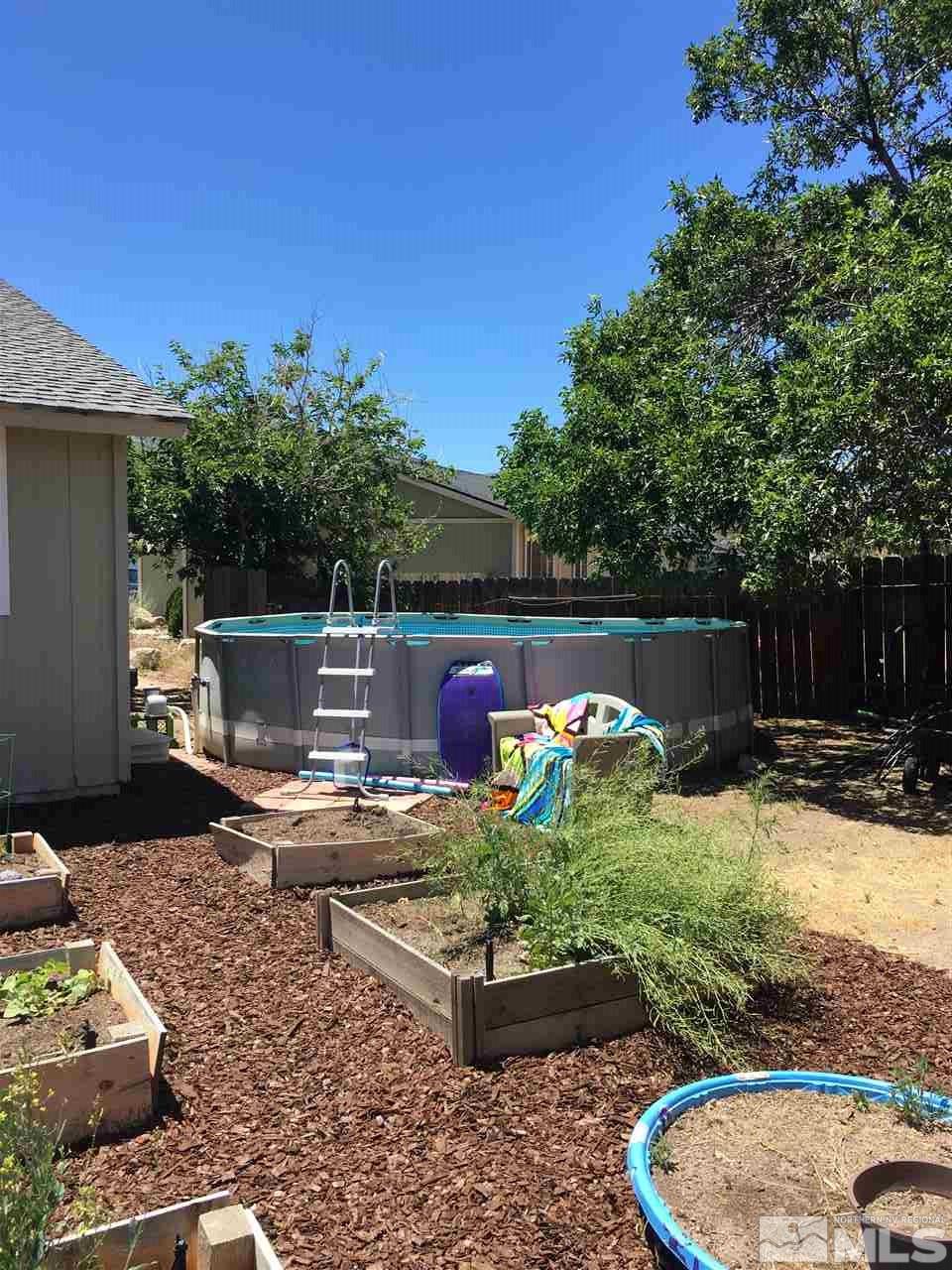 10003 Albite Street Reno, NV 89506 - Photo 3 of 25 a wooden bench sitting in the backyard
