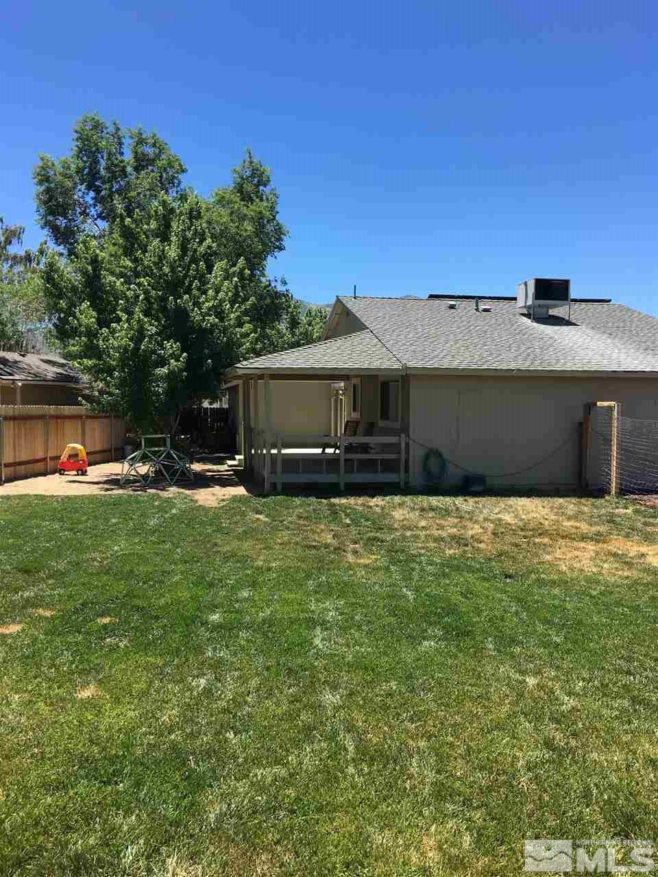 10003 Albite Street Reno, NV 89506 - Photo 8 of 25 a front view of a house with a yard