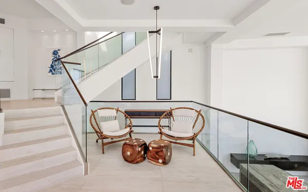 a kitchen with a sink and chairs