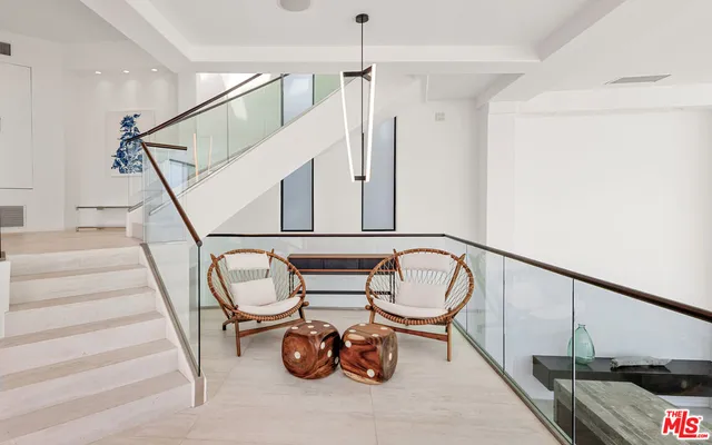 a kitchen with a sink and chairs