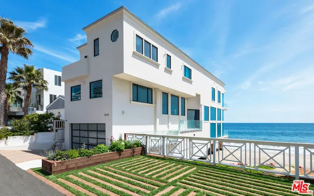 a front view of a house with a yard table and chairs