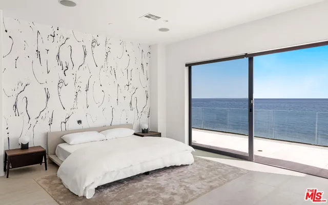 a bathroom with a granite countertop tub sink and mirror