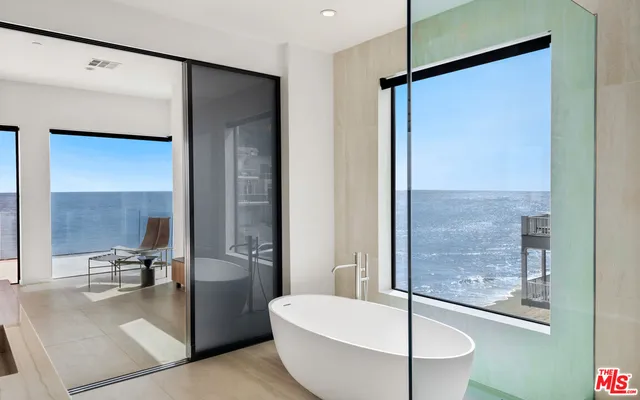 a bedroom with a large window and a large window