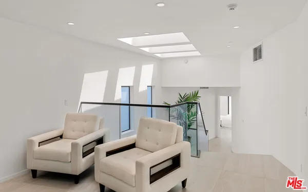 a bedroom with a bed and painting on the wall