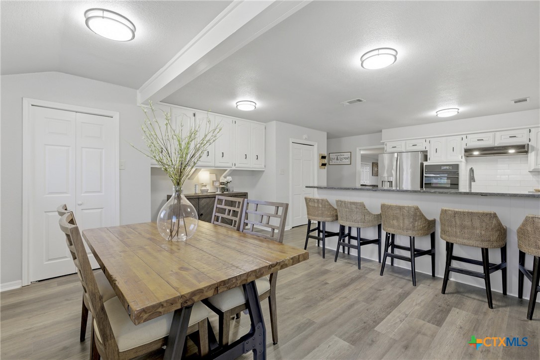 1710 Old Mill Road, Unit 12 Salado, TX 76571 - Photo 15 of 42 a view of a dining room with furniture and wooden floor