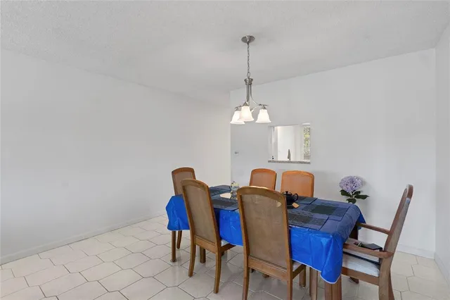 a view of a dining room with furniture wooden floor and chandelier