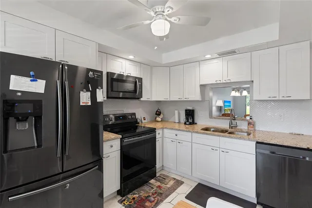 a kitchen with a sink stainless steel appliances and cabinets
