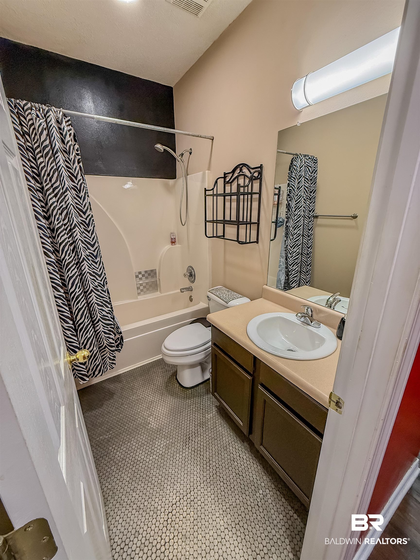 2651 South Juniper Street Foley, AL 36535 - Photo 15 of 20 Full bathroom featuring vanity, shower / bathtub combination with curtain, and tile patterned flooring