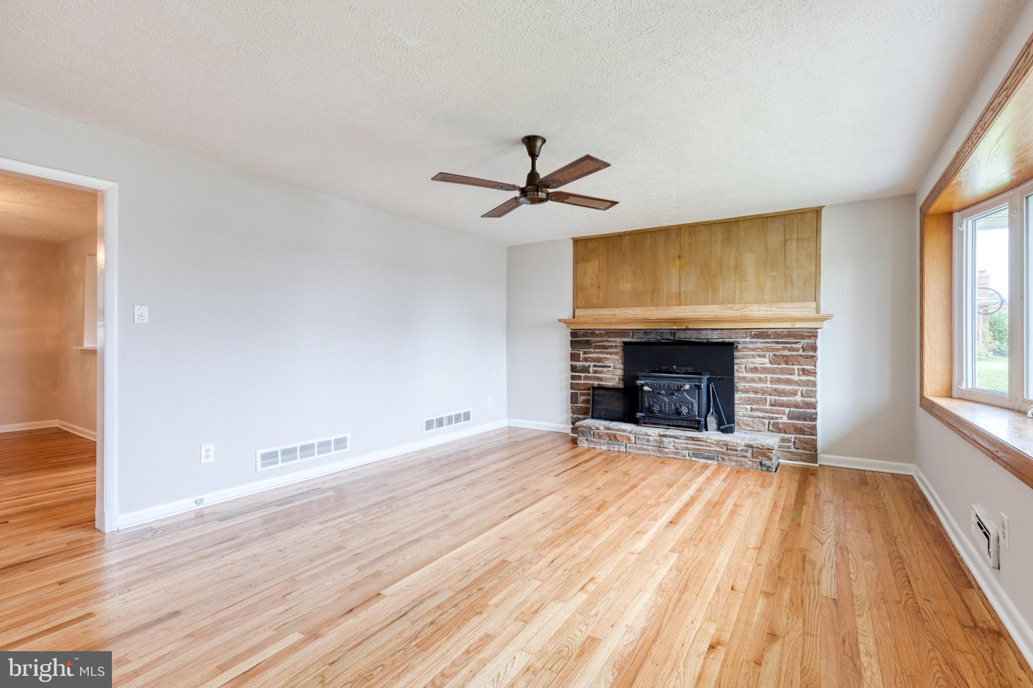 8306 Berkfield Road Baltimore, MD 21237 - Photo 6 of 29 Spacious living area with rustic charm.