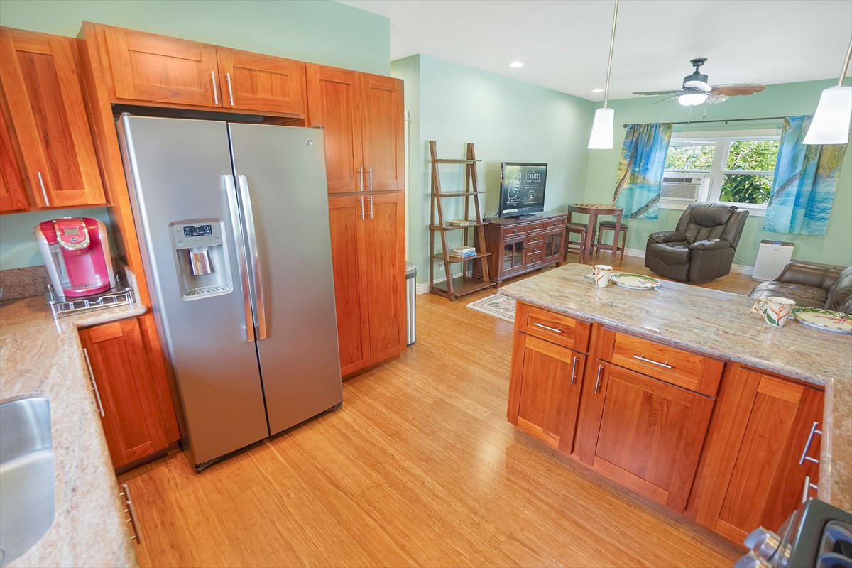 5273 Kawaihau Road, Unit 1 Kapaa, HI 96746 - Photo 11 of 16 a large kitchen with stainless steel appliances a refrigerator and a sink