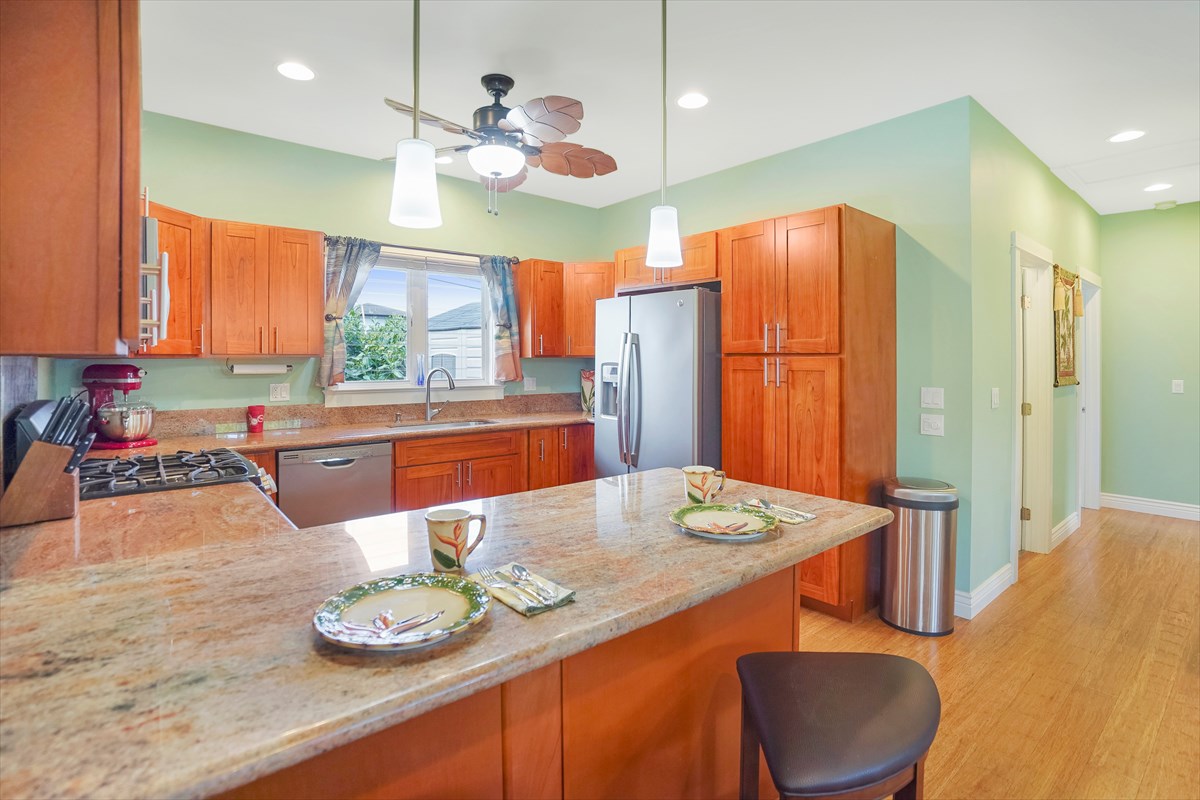 5273 Kawaihau Road, Unit 1 Kapaa, HI 96746 - Photo 12 of 16 a large kitchen with a table and chairs in it
