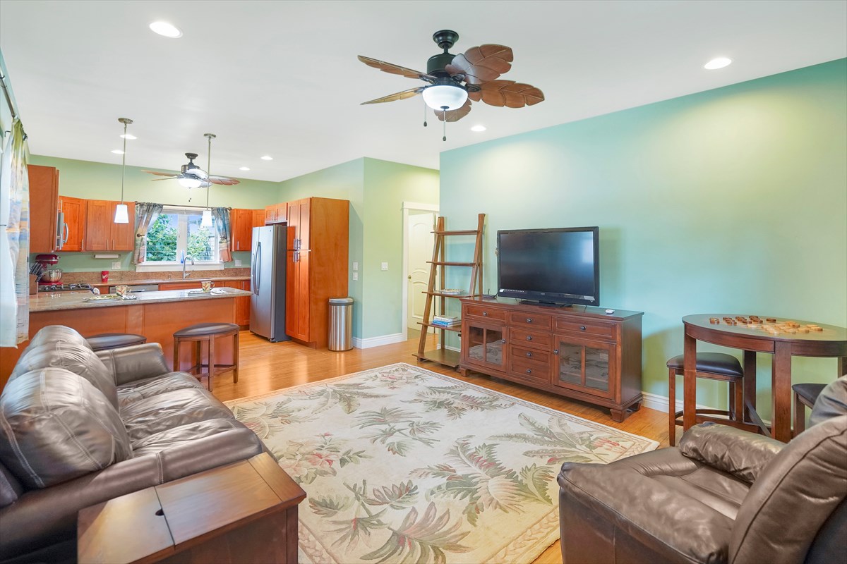 5273 Kawaihau Road, Unit 1 Kapaa, HI 96746 - Photo 13 of 16 a living room with furniture and a flat screen tv