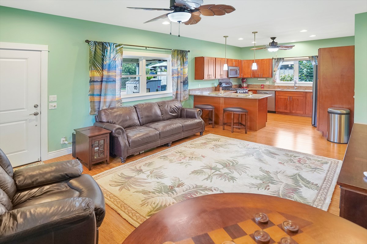 5273 Kawaihau Road, Unit 1 Kapaa, HI 96746 - Photo 14 of 16 a living room with stainless steel appliances kitchen island granite countertop furniture and a large window