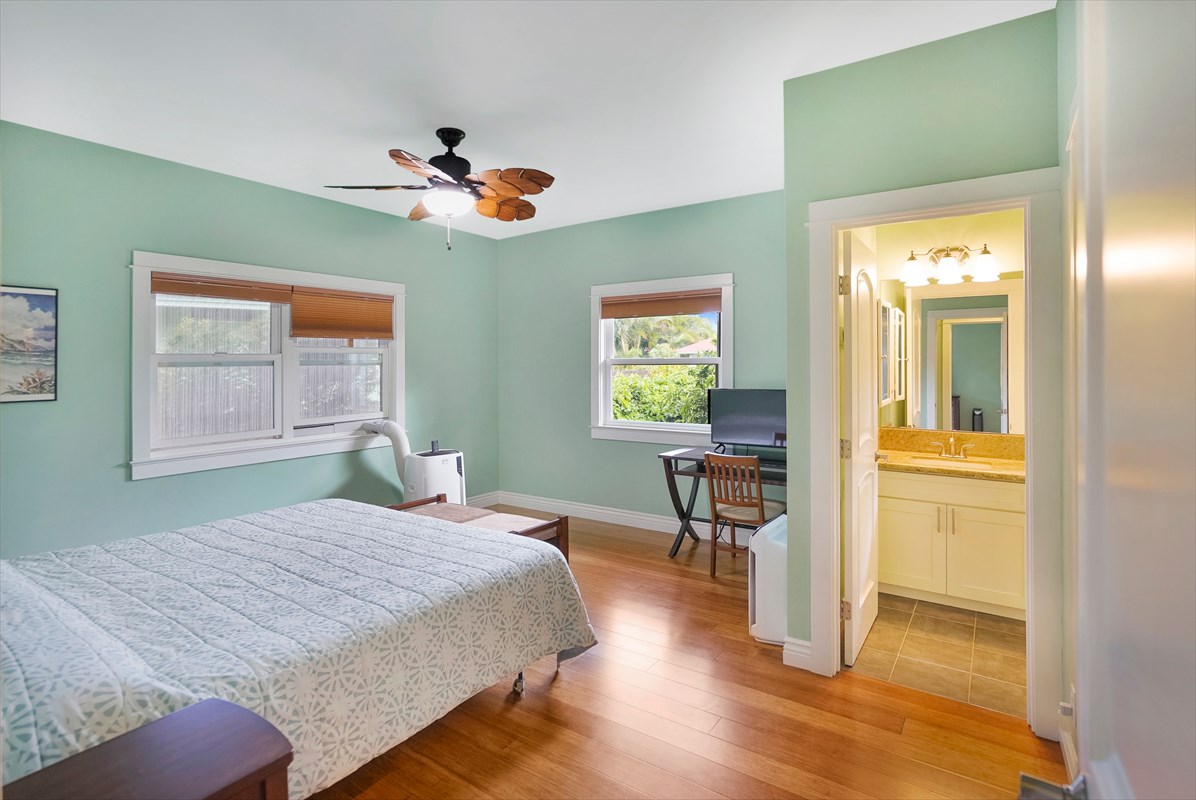 5273 Kawaihau Road, Unit 1 Kapaa, HI 96746 - Photo 6 of 16 a bedroom with a bed and a table in it