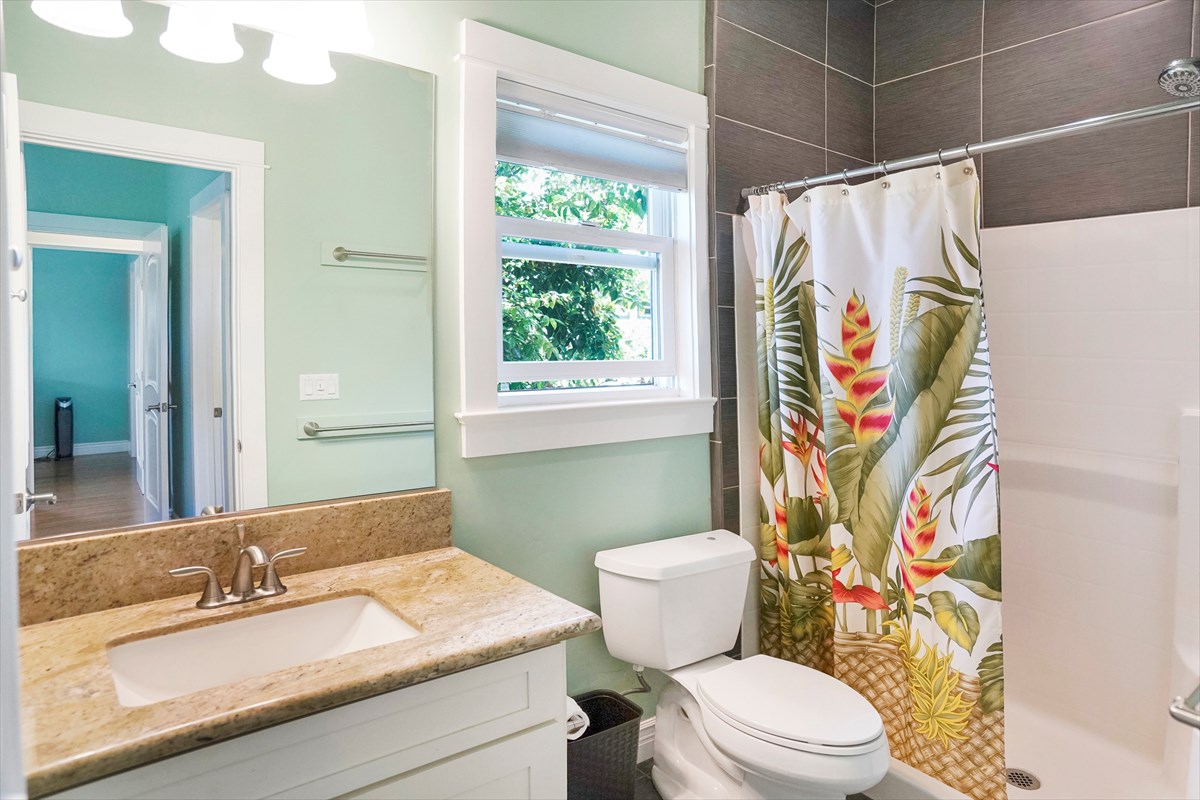 5273 Kawaihau Road, Unit 1 Kapaa, HI 96746 - Photo 8 of 16 a bathroom with a sink a toilet and shower curtain