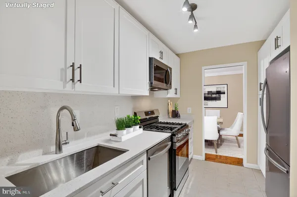 a kitchen that has a sink and a stove