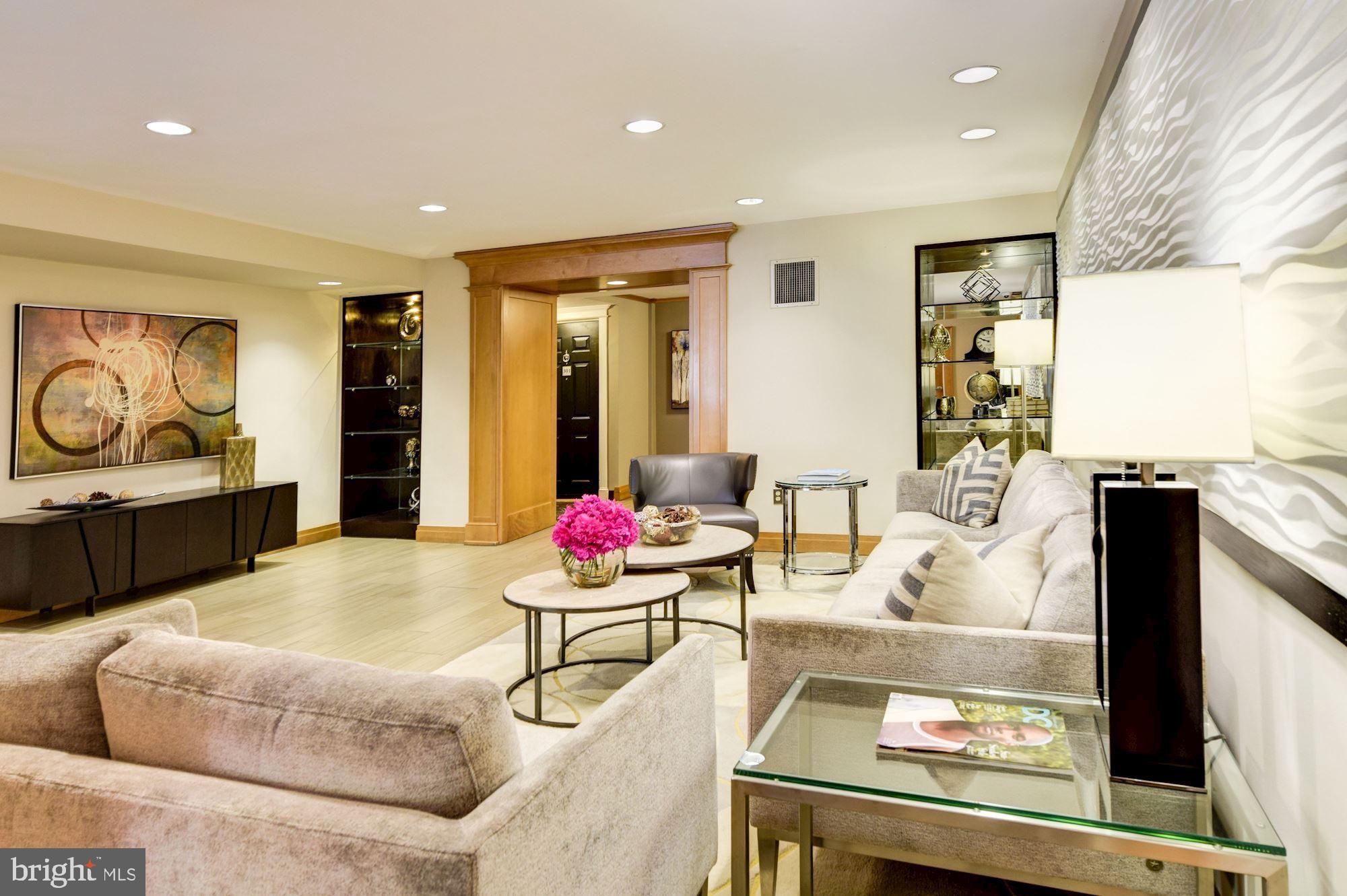 3900 Tunlaw Road Northwest, Unit 103 Washington, DC 20007 - Photo 20 of 41 a living room with furniture and a flat screen tv