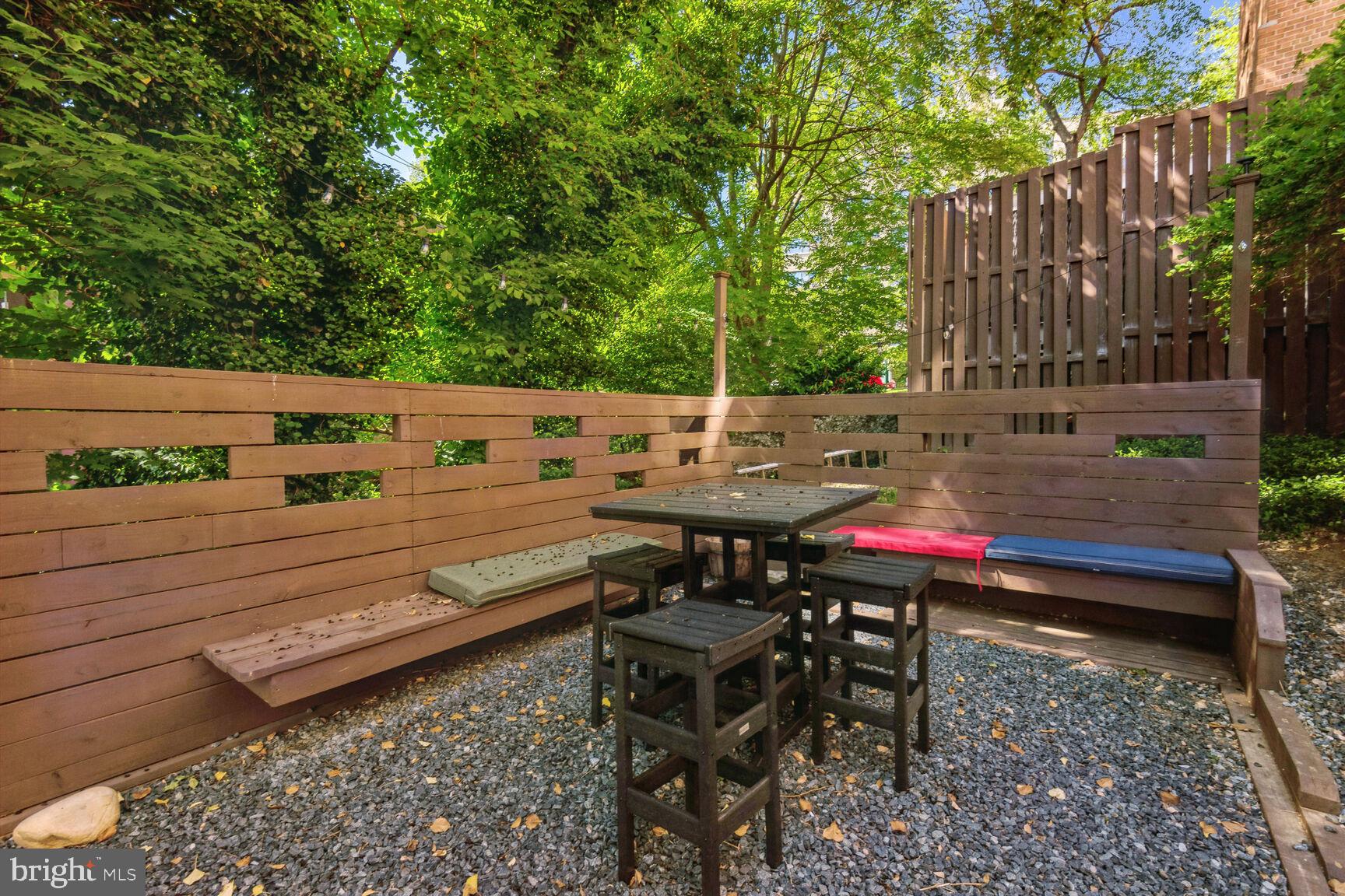 3900 Tunlaw Road Northwest, Unit 103 Washington, DC 20007 - Photo 22 of 41 a view of a tables and chairs on the deck