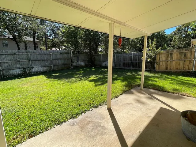 a view of a backyard with grass