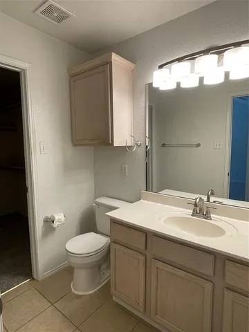 a bathroom with a sink toilet and mirror