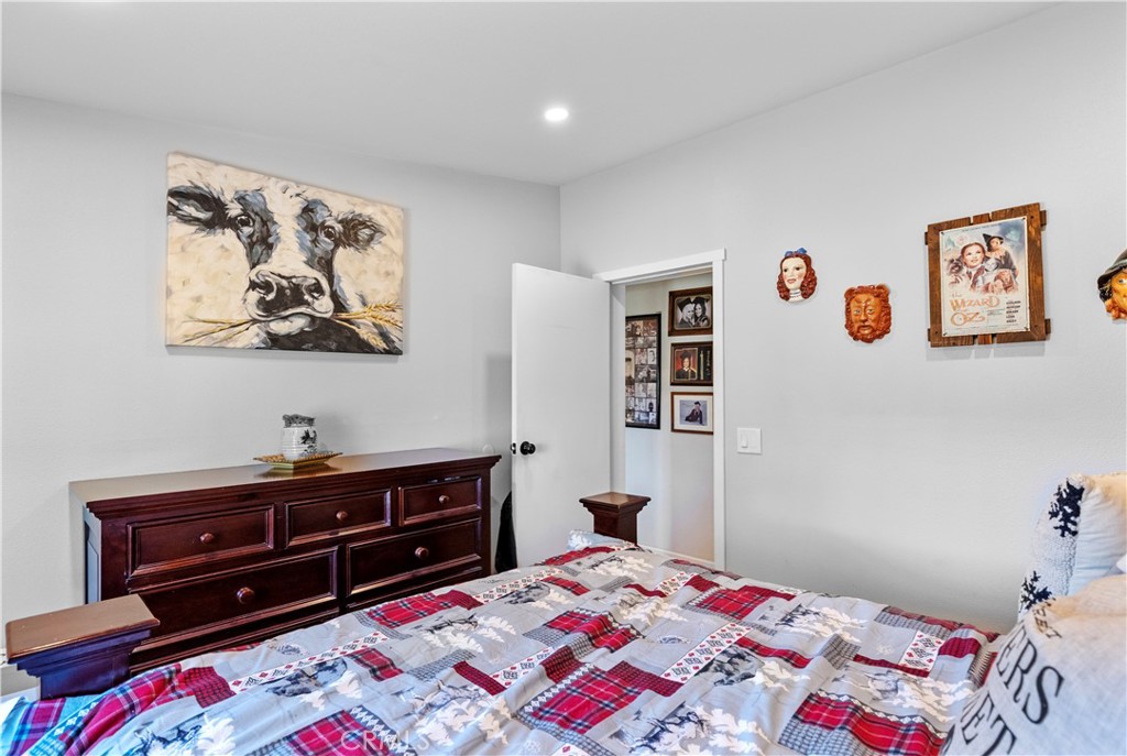 17500 High Gun Drive Tehachapi, CA 93561 - Photo 32 of 46 a bedroom with a bed and a dresser in it