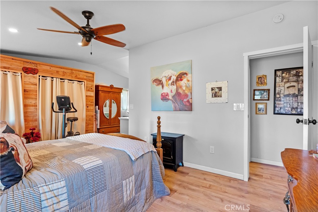 17500 High Gun Drive Tehachapi, CA 93561 - Photo 36 of 46 a bedroom with a bed and a chandelier