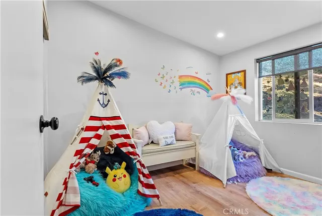 a view of a hallway with workspace and a window