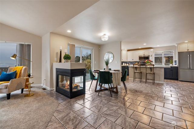 a living room with furniture a dining table and kitchen view