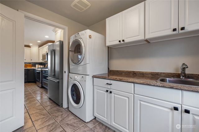 a utility room with sink dryer and washer