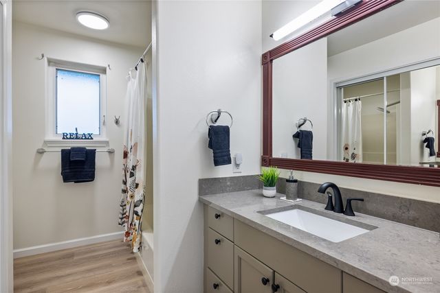 a bathroom with a granite countertop sink and a mirror