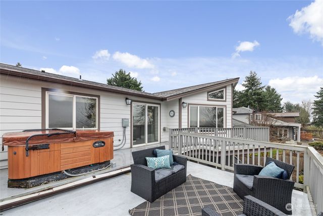 a balcony with furniture and wooden floor