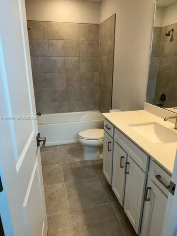 a utility room with dryer and cabinets