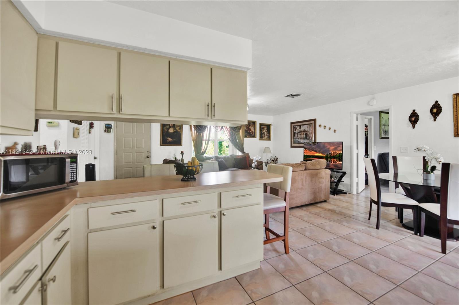 1480 Southwest 17th Street Naples, FL 34117 - Photo 12 of 36 a kitchen with cabinets and chairs