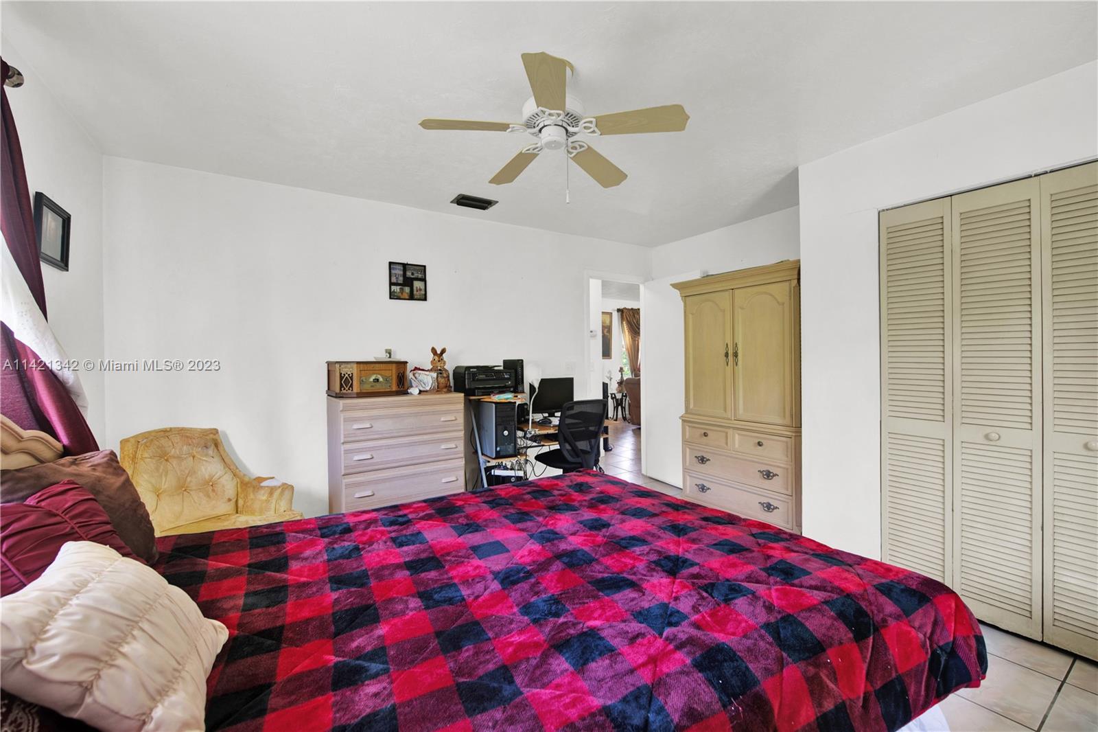 1480 Southwest 17th Street Naples, FL 34117 - Photo 17 of 36 a bed room with a bed and a chair