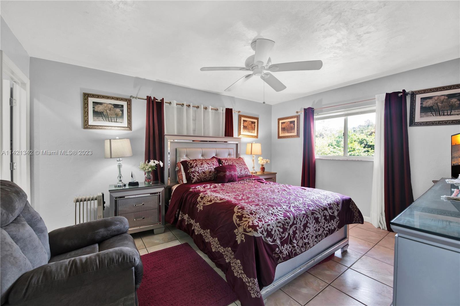 1480 Southwest 17th Street Naples, FL 34117 - Photo 18 of 36 a bedroom with a bed couch and window