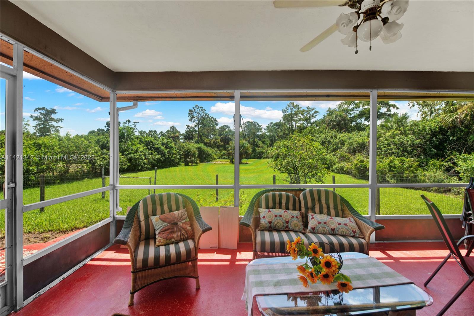 1480 Southwest 17th Street Naples, FL 34117 - Photo 25 of 36 a view of a chairs and table in patio with a yard