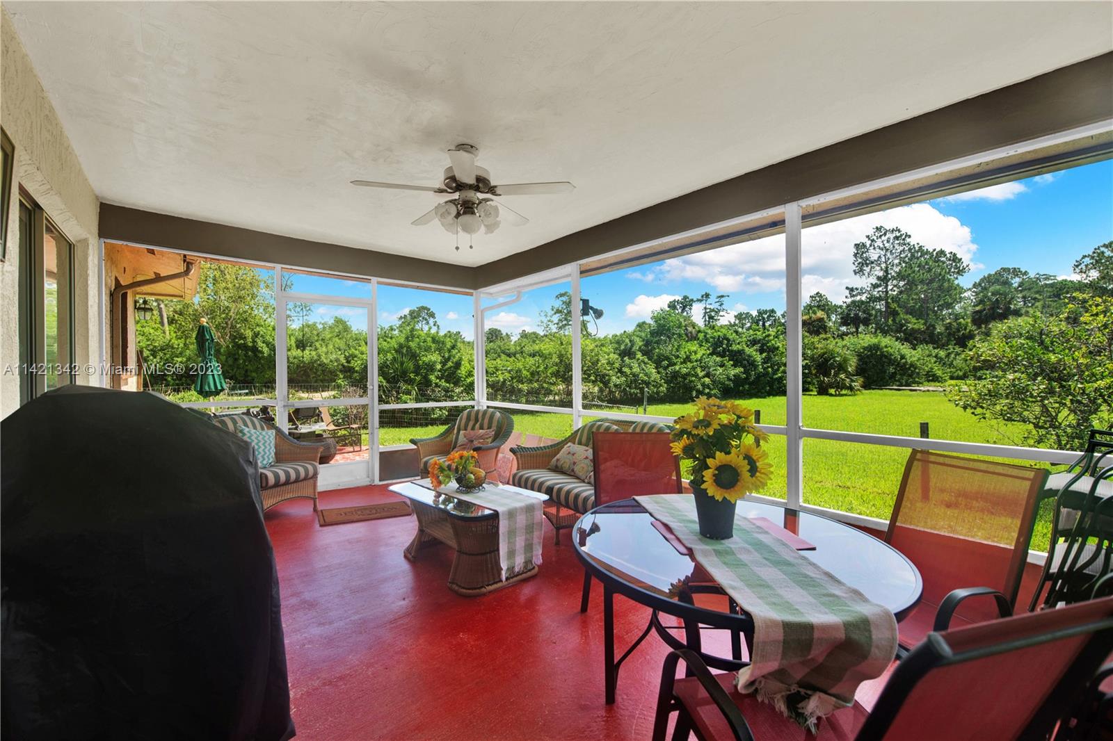 1480 Southwest 17th Street Naples, FL 34117 - Photo 26 of 36 a view of a patio with lawn chairs and a yard