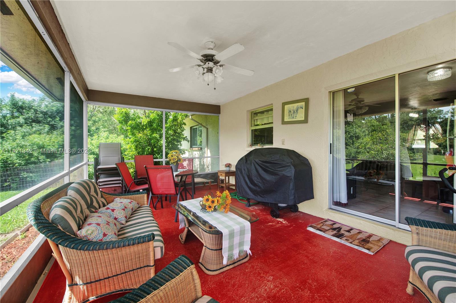 1480 Southwest 17th Street Naples, FL 34117 - Photo 27 of 36 a living room with furniture and a floor to ceiling window